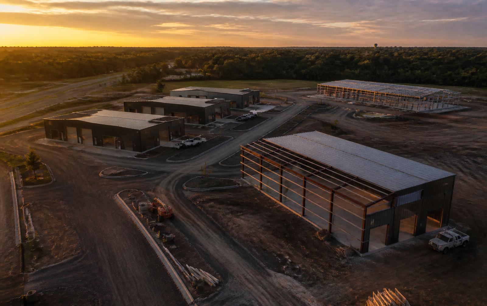 Aerial view of a flex garage development under construction at sunset